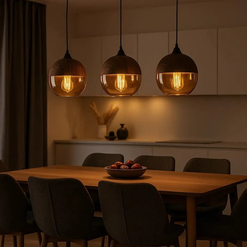 Dining area with pendant lights, table, and chairs in a dimly lit room.