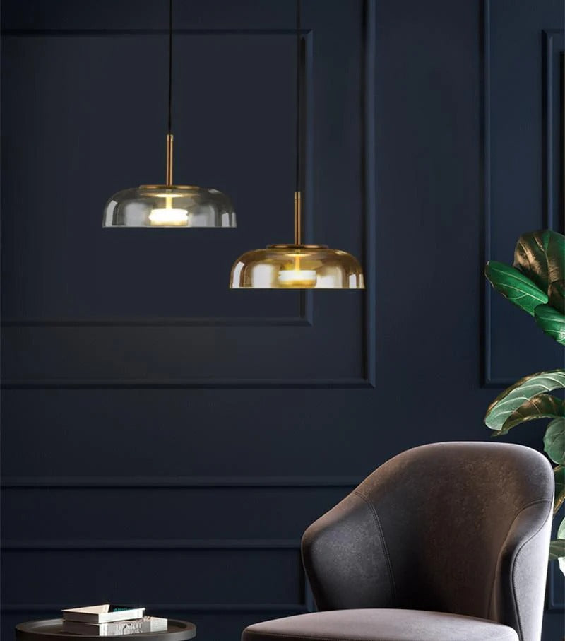 Modern interior with gold pendant lights and a dark blue wall.