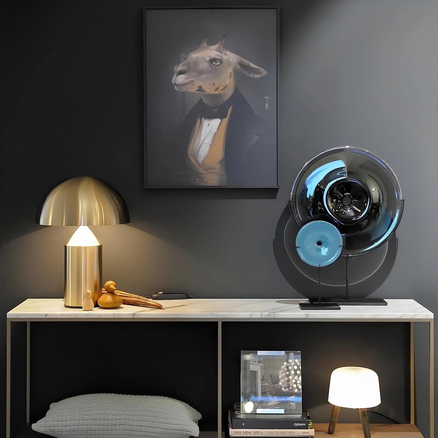 Modern interior with a lamp, books, and decorative items on a shelf against a dark wall with a framed picture.