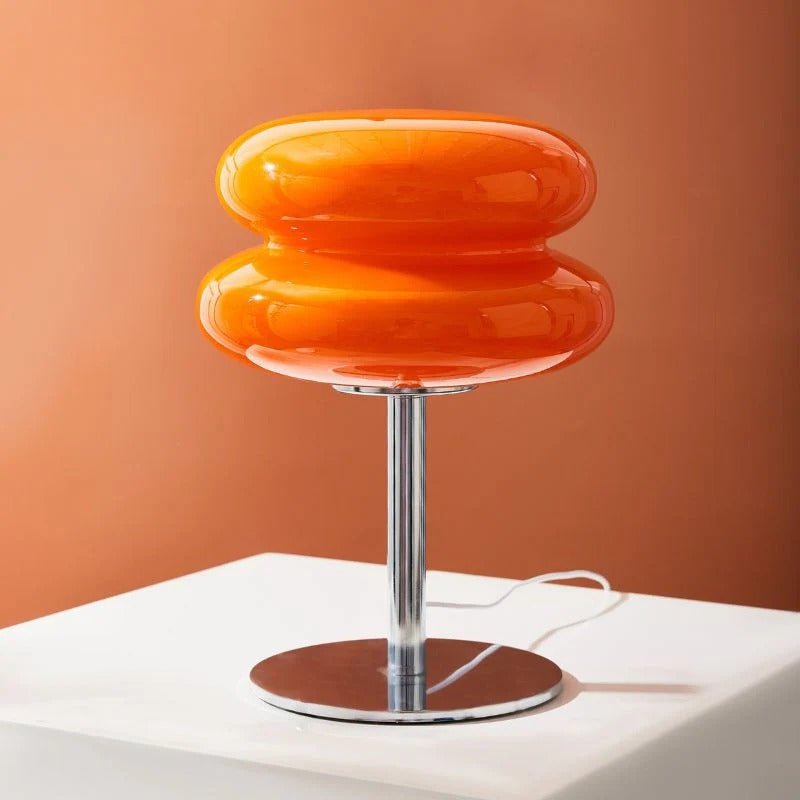 Orange TABLE LAMP on a white platform with an orange background