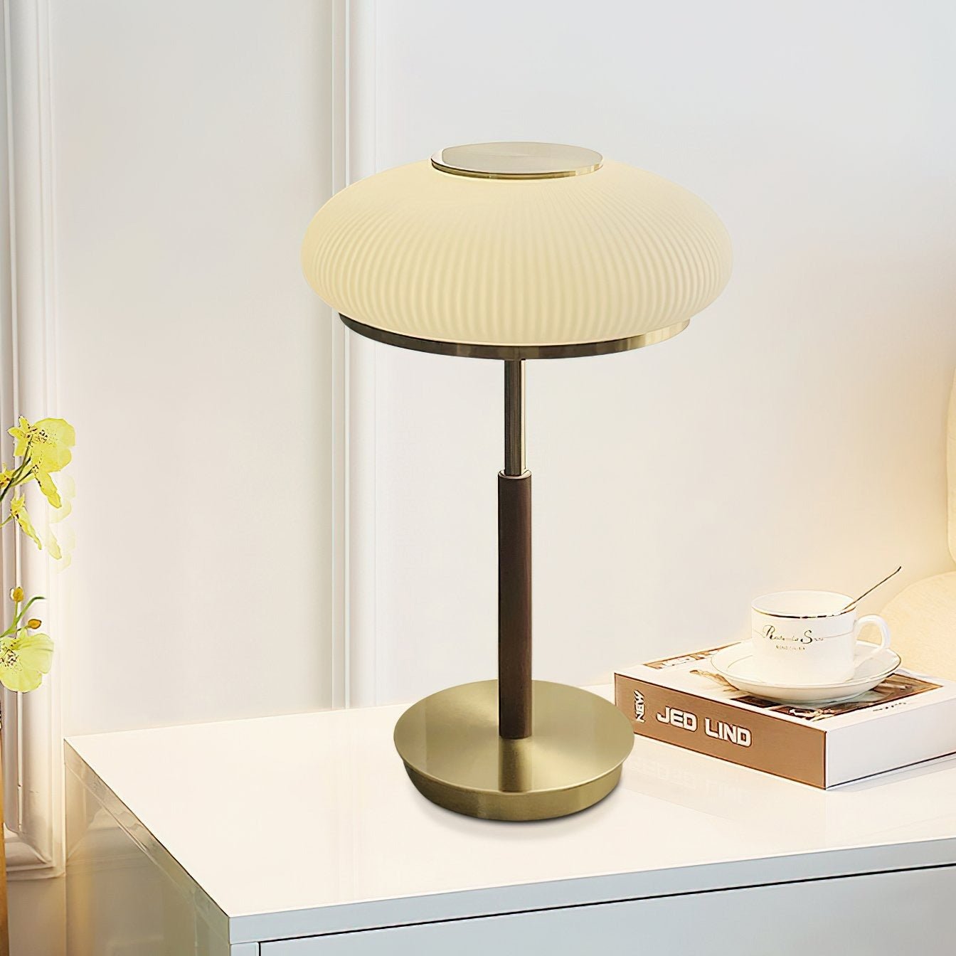 Matsutake Bloom Table Lamp – Elegant Table Lighting on a bedside table with a cup and books.