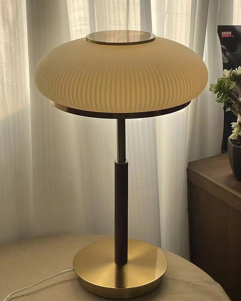 Modern table lamp with a ribbed design on a white curtain background