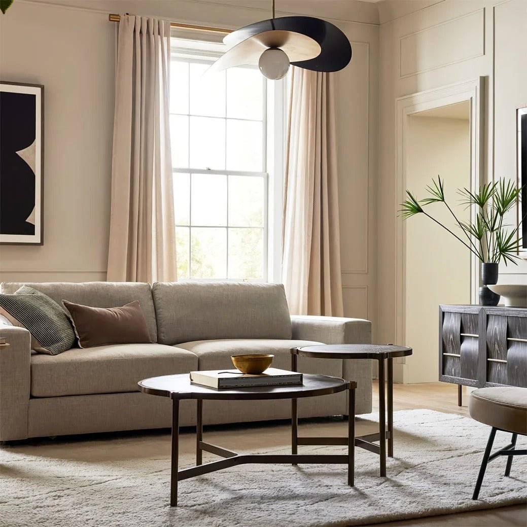 Olivia Pendant Light with frosted glass globe and modern brass finish over table