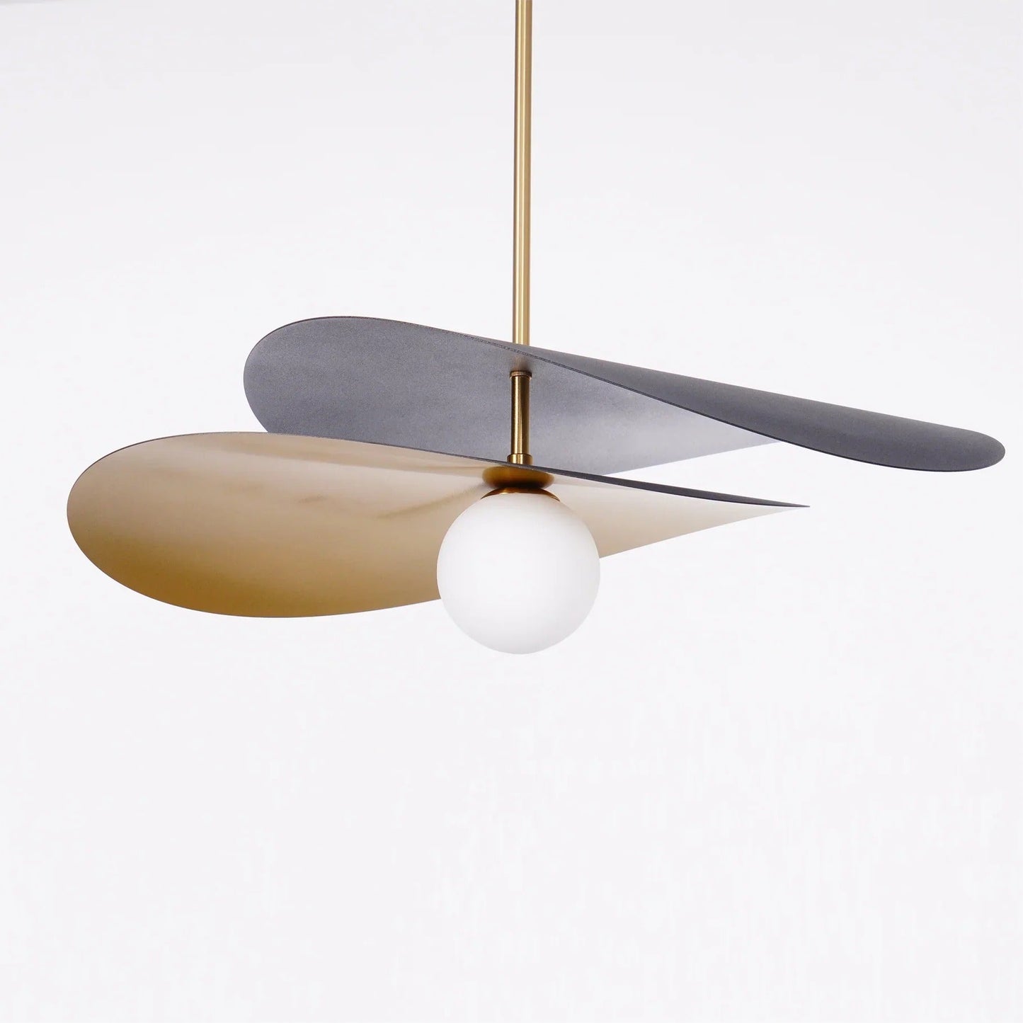 Olivia Pendant Light with frosted glass globe and modern brass finish over dining table