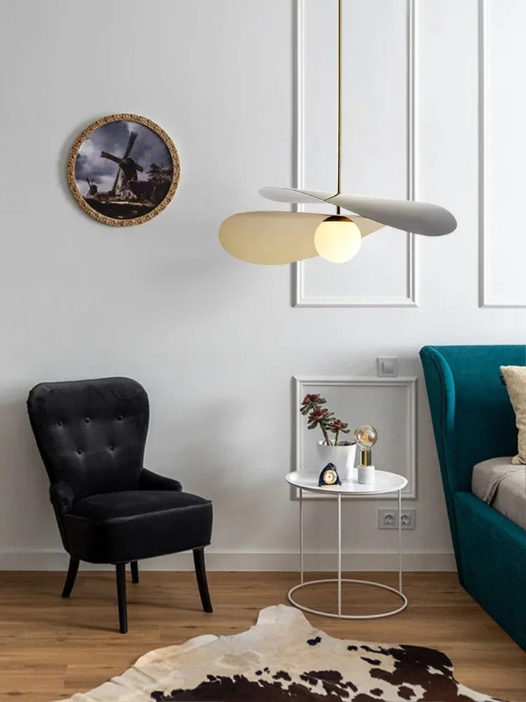 Olivia Pendant Light with frosted glass globe and modern brass finish over dining table
