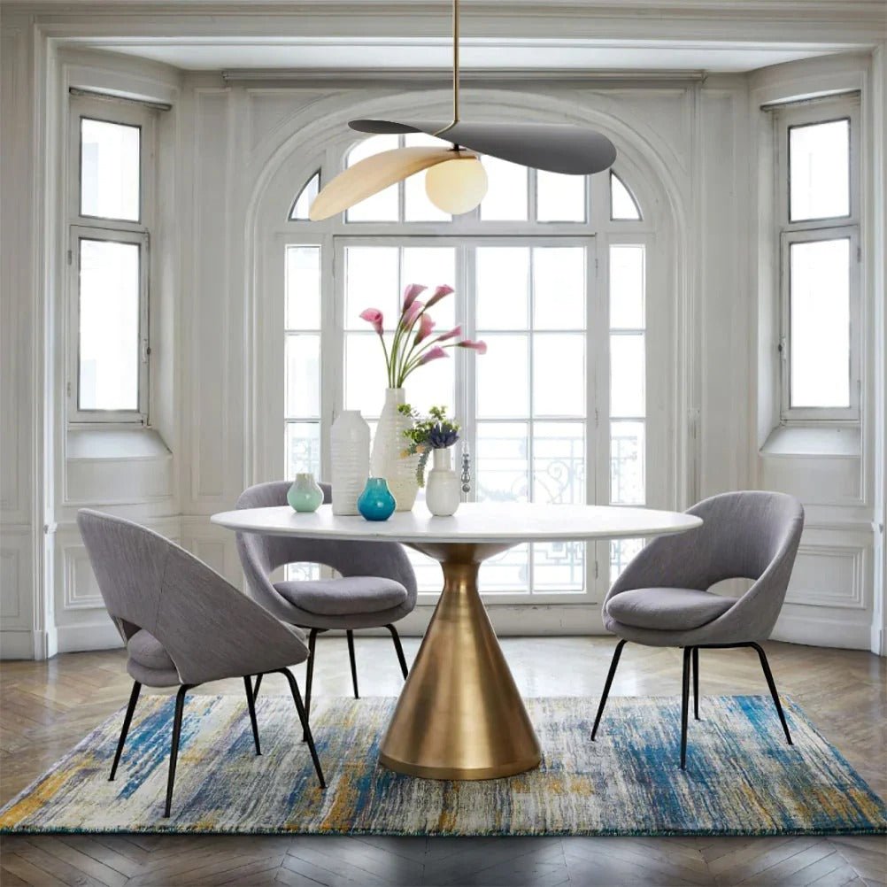 Olivia Pendant Light with frosted glass globe and modern brass finish over dining table