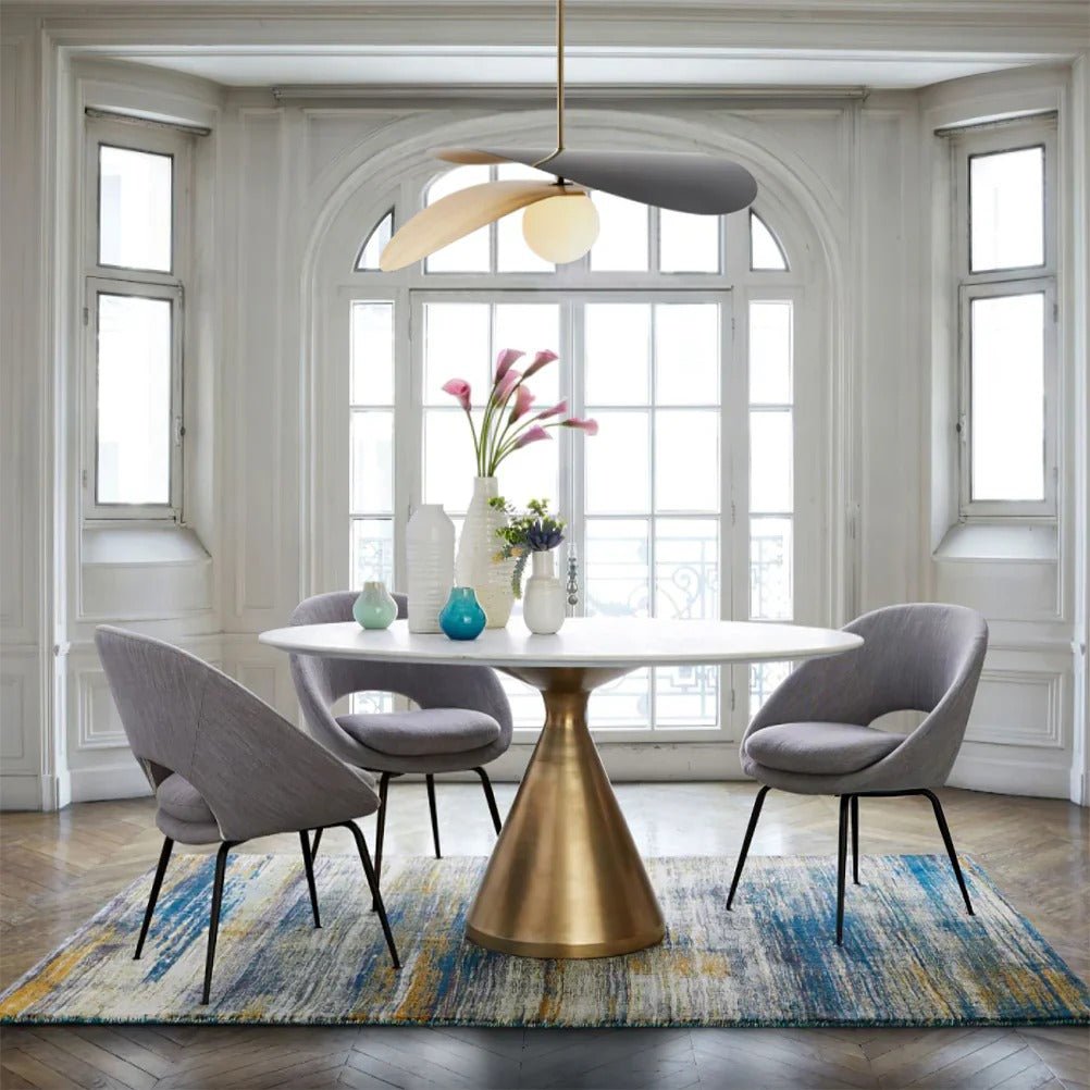 Olivia Pendant Light with frosted glass globe and modern brass finish over dining table