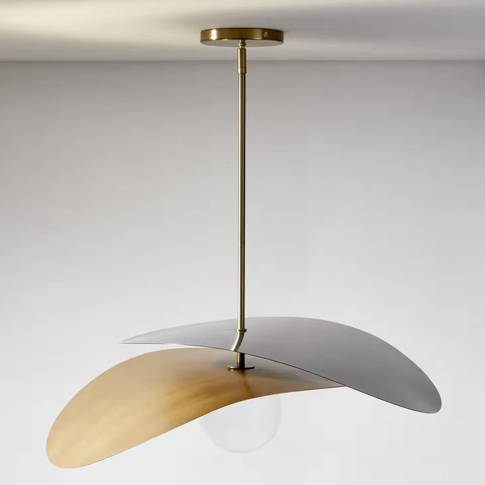 Olivia Pendant Light with frosted glass globe and modern brass finish over dining table