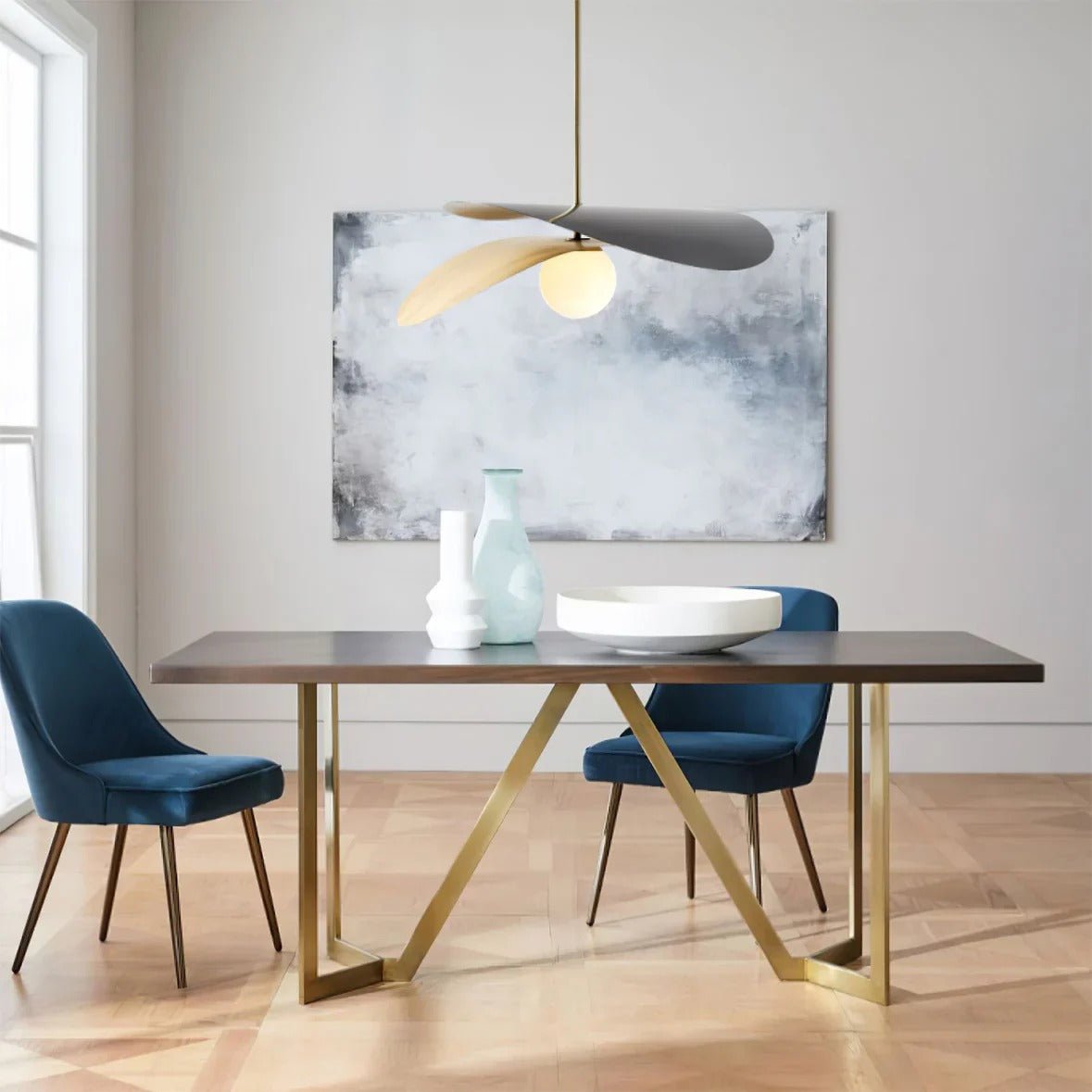 Olivia Pendant Light with frosted glass globe and modern brass finish over dining table