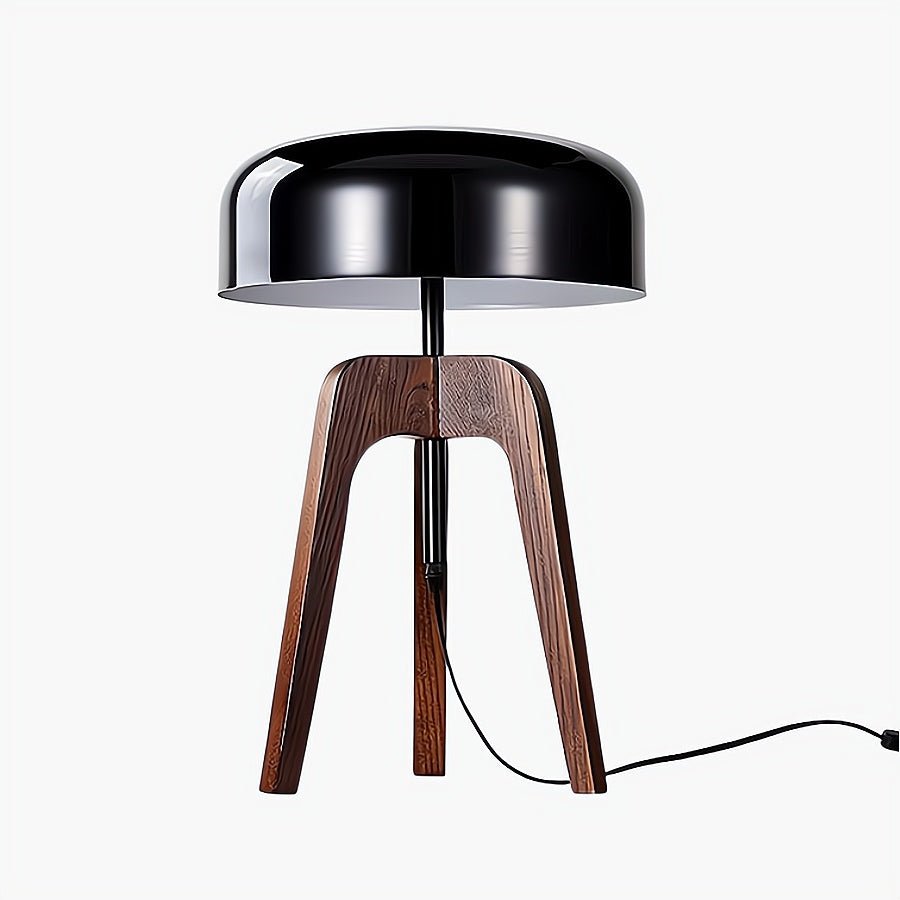 Table lamp with black metallic shade and wooden legs on a white background