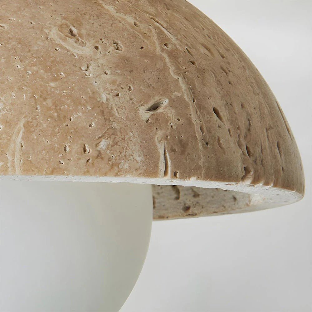 Close-up of a textured ceramic mushroom-shaped object on a white background