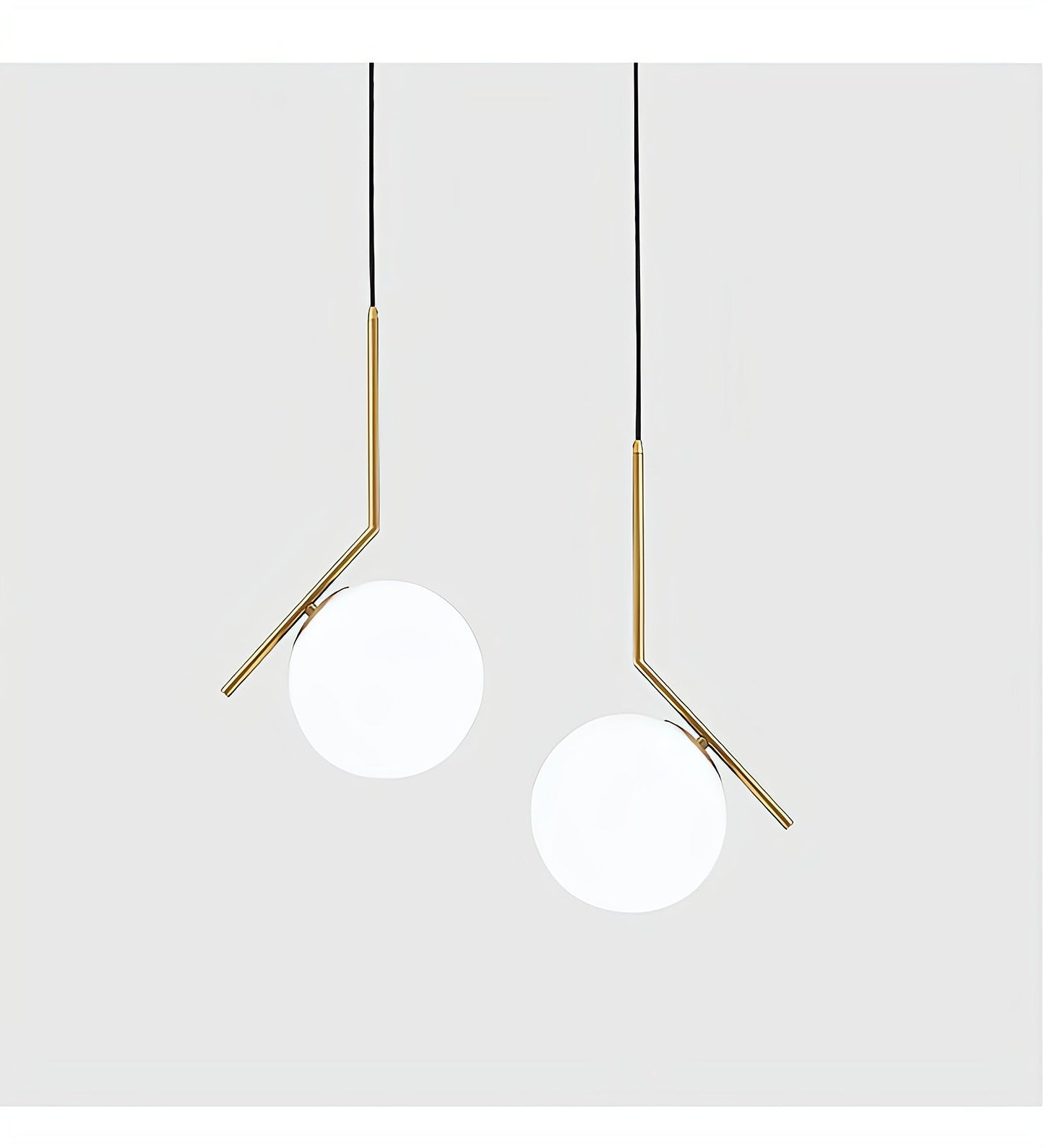 Two modern pendant lights with gold fixtures on a white background