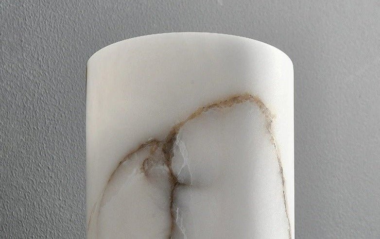 Marble-patterned cylindrical object against a gray background