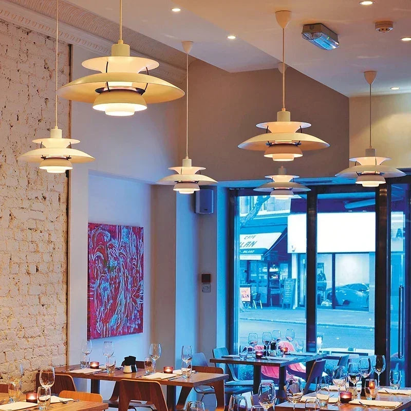 various modern pendant lights, of the same model, iluminating a cafe and bring more style to it