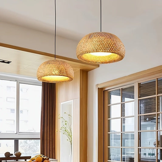 Two woven pendant lights hanging in a room with large windows and wooden furniture.