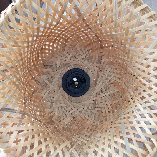 Close-up of a woven wooden lampshade with a black light bulb holder.