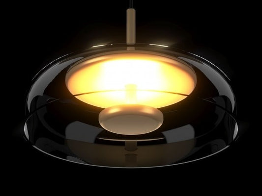 Modern pendant light with a black shade and gold interior on a dark background