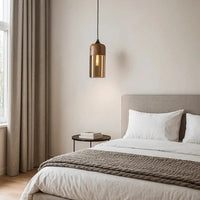 Modern bedroom with a bed, side table, and pendant light.