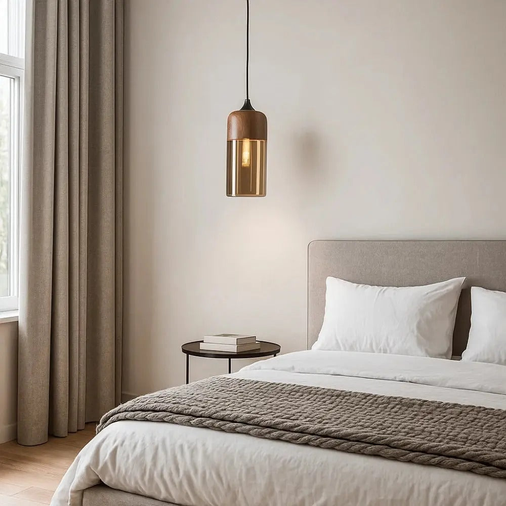 Modern bedroom with a bed, side table, and pendant light.