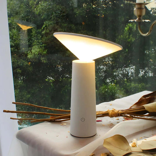Rivo cordless table lamp showcasing modern sculptural design with adjustable light for ambiance.