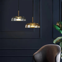 Modern interior with gold pendant lights and a dark blue wall.