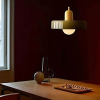 Dining room with a wooden table, chairs, and a pendant light fixture.