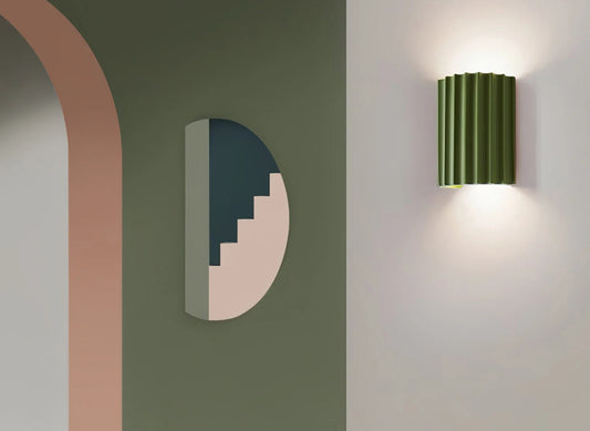 Modern wall light fixture on a neutral wall with abstract wall art.