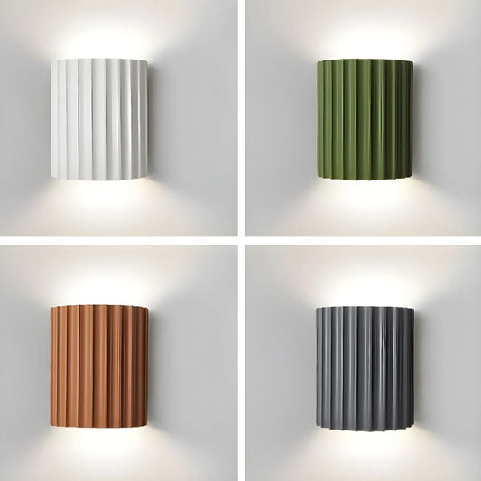 Four wall lights in different colors on a gray background