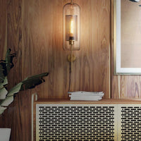 Decorative wall sconce with a wooden panel and framed picture in the background