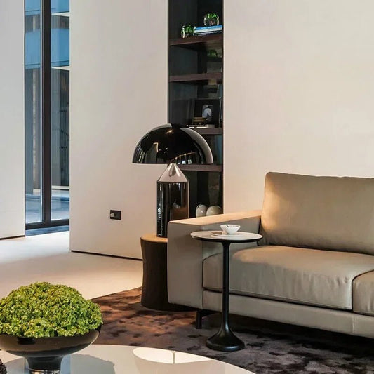 Modern living room with beige sofa, side table, and decorative elements.