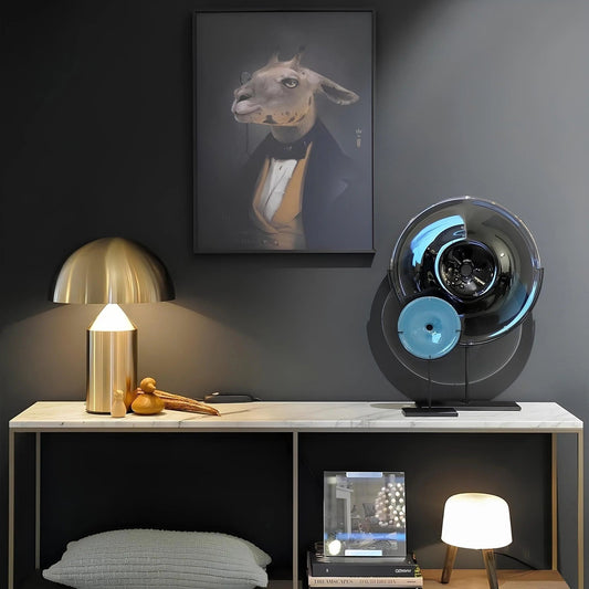Modern interior with a lamp, books, and decorative items on a shelf against a dark wall with a framed picture.