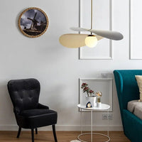 Olivia Pendant Light with frosted glass globe and modern brass finish over dining table