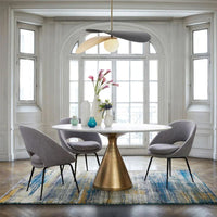 Olivia Pendant Light with frosted glass globe and modern brass finish over dining table