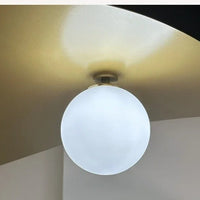 Olivia Pendant Light with frosted glass globe and modern brass finish 