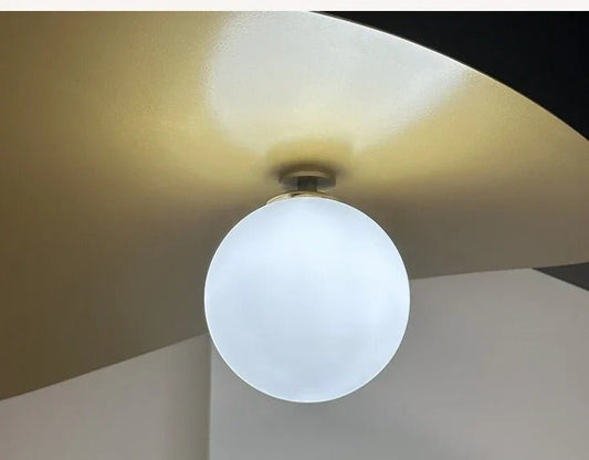 Olivia Pendant Light with frosted glass globe and modern brass finish 