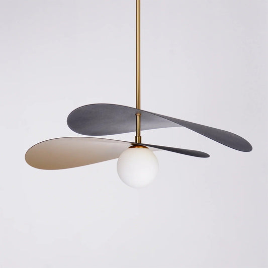 Olivia Pendant Light with frosted glass globe and modern brass finish over dining table