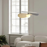 Olivia Pendant Light with frosted glass globe and modern brass finish over table