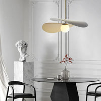 Olivia Pendant Light with frosted glass globe and modern brass finish over dining table