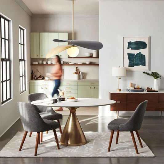 Olivia Pendant Light with frosted glass globe and modern brass finish over dining table
