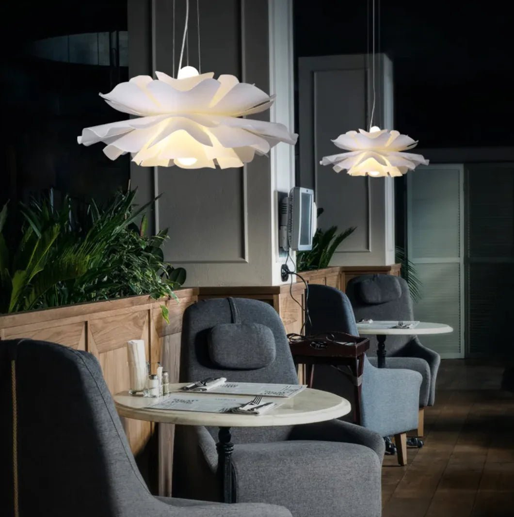Modern interior with white flower-shaped pendant lights in a restaurant setting.