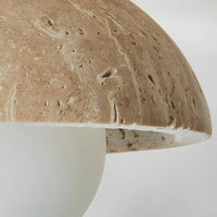 Close-up of a textured ceramic mushroom-shaped object on a white background