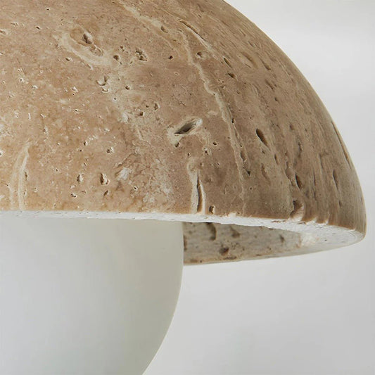 Close-up of a textured ceramic mushroom-shaped object on a white background