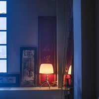 Room with a window, lamp, and wall decorations