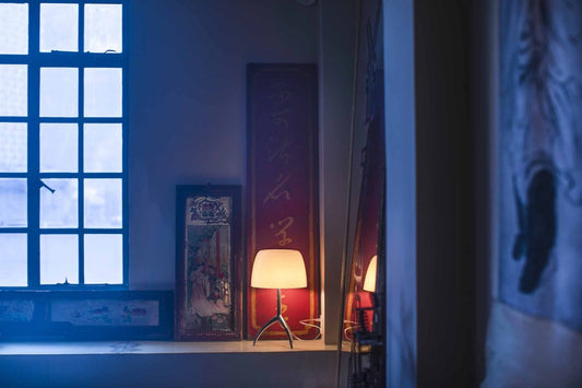 Room with a window, lamp, and wall decorations