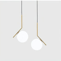 Two modern pendant lights with gold fixtures on a white background