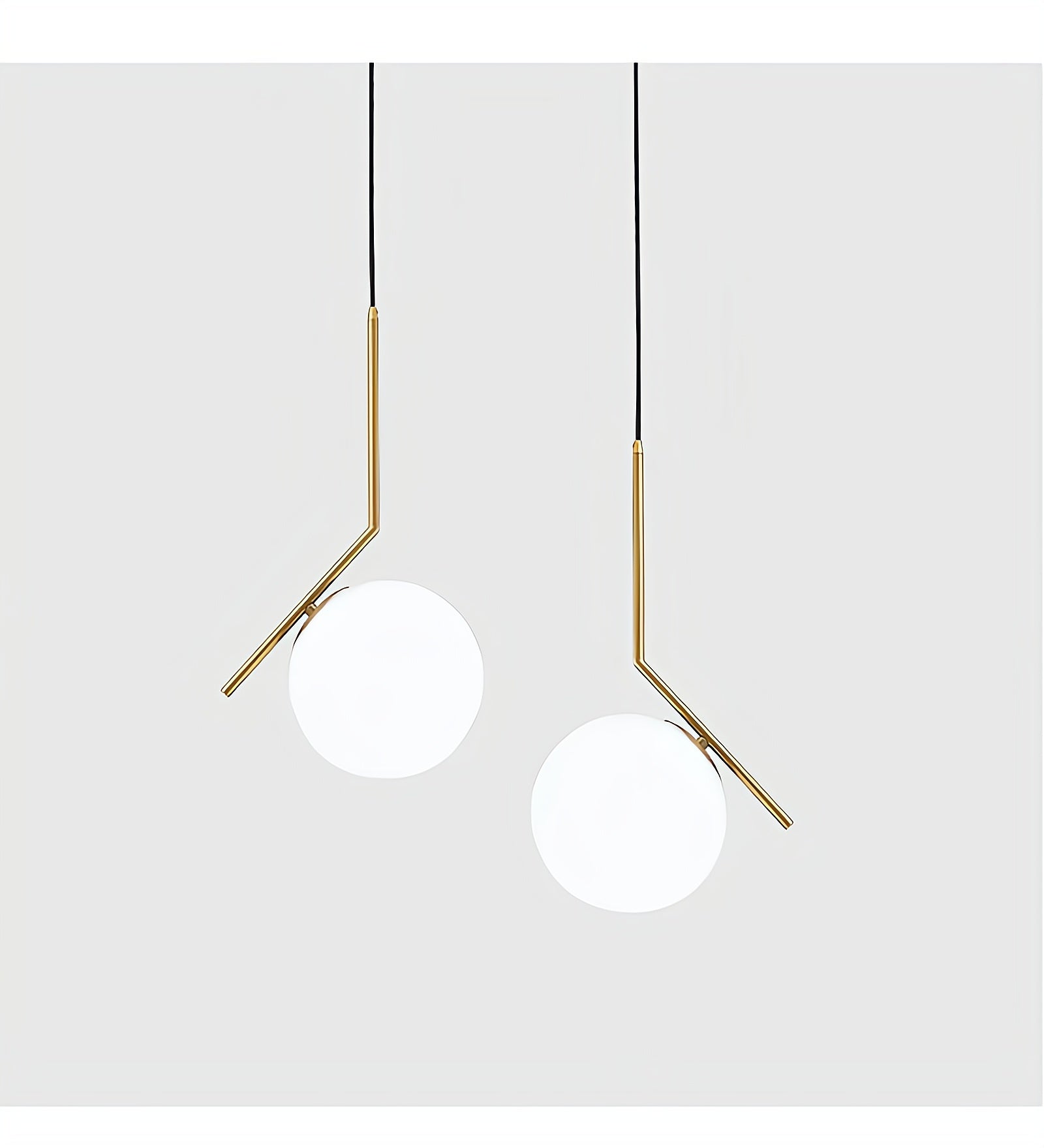 Two modern pendant lights with gold fixtures on a white background