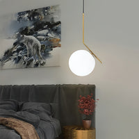 Modern pendant light hanging above a bed with a painting of a wolf on the wall.