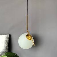 Modern pendant light with gold fixture and white glass shade on a neutral background