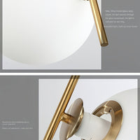 Wall-mounted light fixture with gold finish and white shade on a gray background
