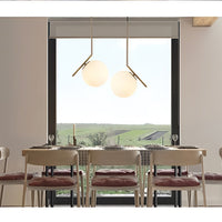 Modern dining room with a large window view of greenery